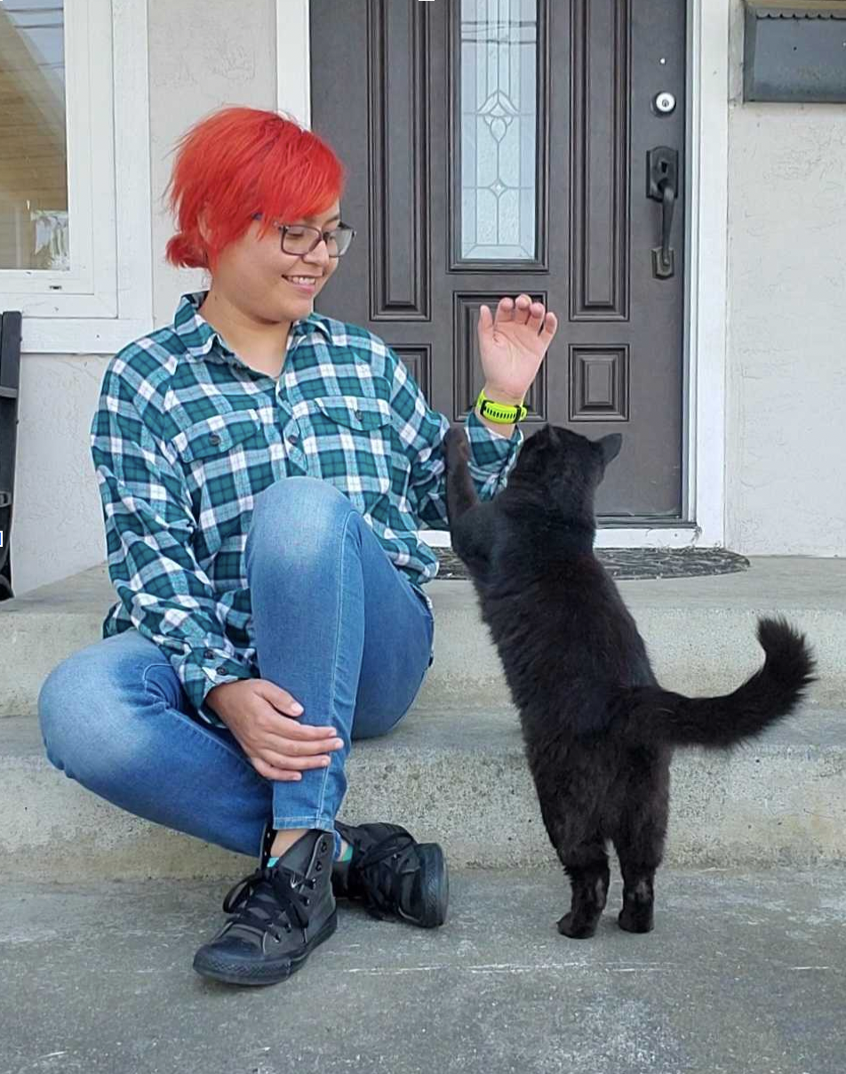 Monica with a cat on steps